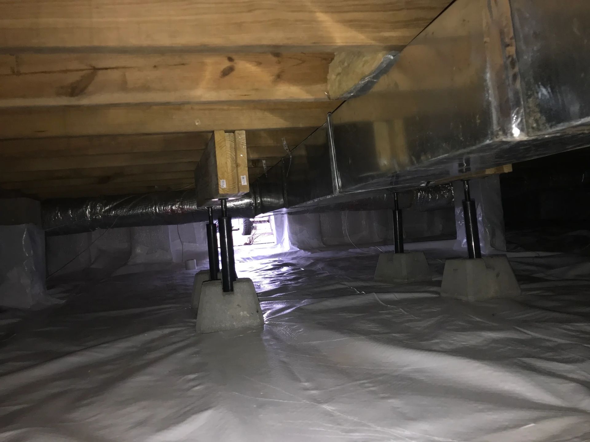 Crawl space with ductwork and insulation